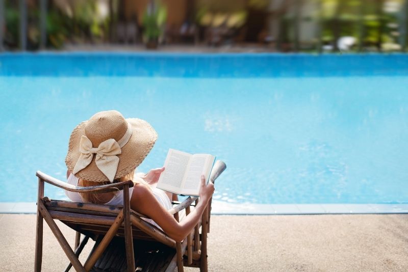 girl sitting beside the clear and wide pool Newcastle