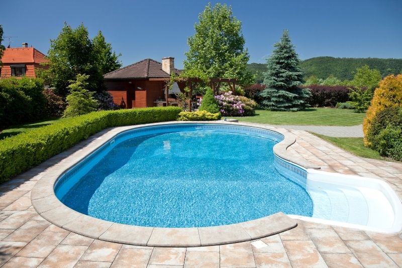 beautiful place with a concrete pool in the center and clear blue sky