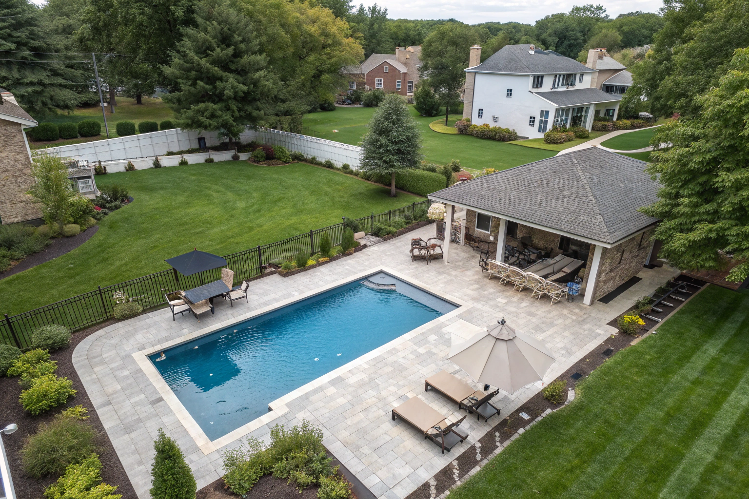 A rectangular shaped swimming pool on a backyard